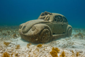 Child sleeping on a VW Bug